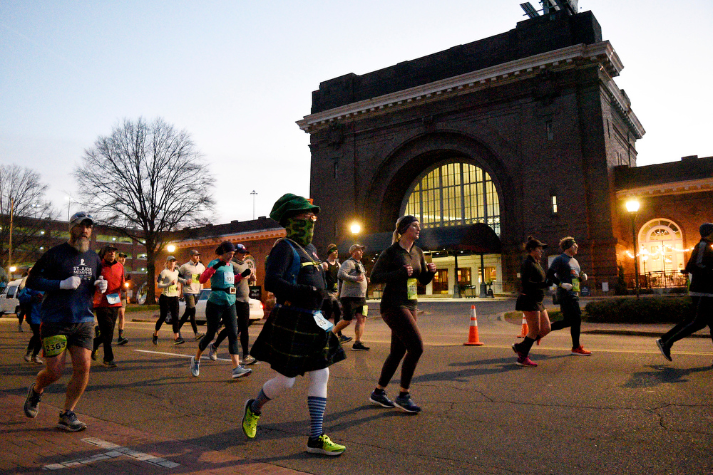 Staff Photo by Robin Rudd / Having finished the first mile runners pass the Choo Choo on Market Street. The 5th Erlanger Chattanooga Marathon was run on March 8, 2020.