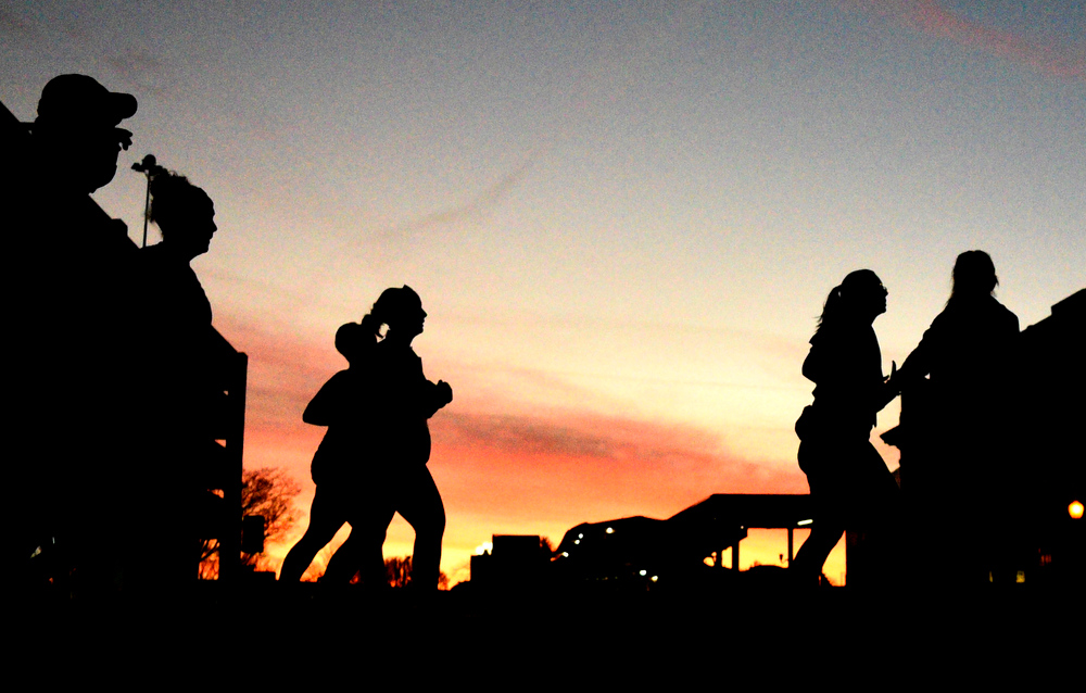 Staff Photo by Robin Rudd / The sunrise begins as the runners pass on Market Street. The 5th Erlanger Chattanooga Marathon was run on March 8, 2020.