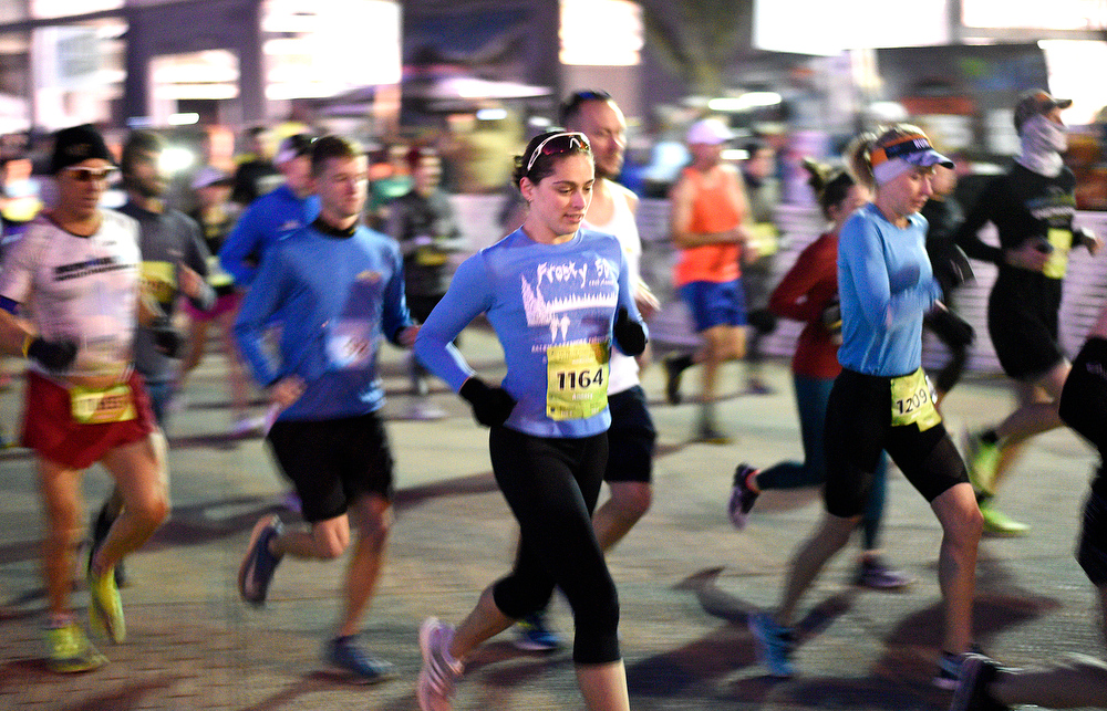 Staff Photo by Robin Rudd / Runners head north up Reggie White Blvd. before sunrise at the start of the race. The 5th Erlanger Chattanooga Marathon was run on March 8, 2020.