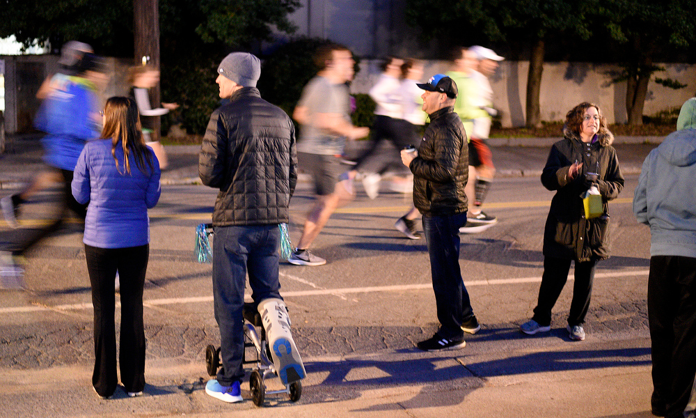 Staff Photo by Robin Rudd / Spectators watch as the racers dash past at the beginning of the marathon. The 5th Erlanger Chattanooga Marathon was run on March 8, 2020.