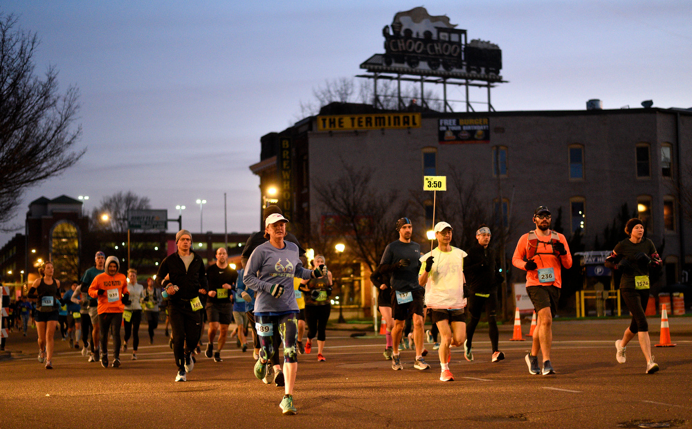 Staff Photo by Robin Rudd / With the sun not yet up the participants in the Erlanger Chattanooga Marathon have just completed one mile as the run south of Market Street past the Choo Choo. The 5th Erlanger Chattanooga Marathon was run on March 8, 2020.