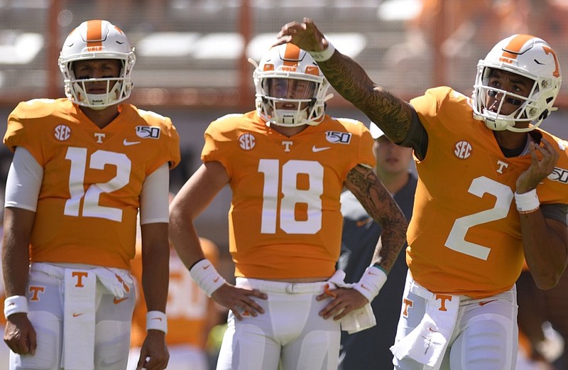 Staff Photo by Robin Rudd/  Vol backup quarterbacks J.T. Shrout (12) and Brian Maurer (18) watch Jarrett Guarantano (2) warm up.  The University of Tennessee Volunteers opened the season wit the Georgia State Panthers at Neyland Stadium on August 31, 2019.  