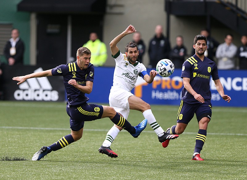 The Oregonian photo by Sean Meagher via AP / The Portland Timbers' Diego Valeri, center, shoots during Sunday's home win against Nashville SC.