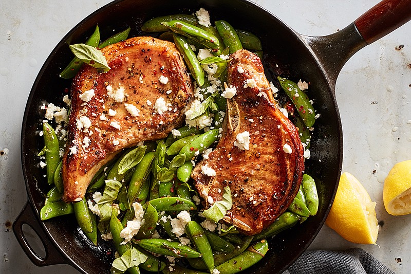 FILE -- One-pan pork chops with feta, snap peas and mint, in New York, May 21, 2019. The majority of these recipes will deliver a whole meal in a single pot, pan or skillet, full stop. Food Stylist: Rebecca Jurkevich. (Johnny Miller/The New York Times)