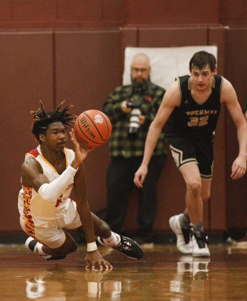 Staff photo by Troy Stolt / Howard's Kerrick Thorne (5) makes a diving pass on a loose ball during the boys' Class AA basketball sectional championship game between Upperman and Howard on Monday, March 9, 2020 in Chattanooga, Tenn. Upperman would win the game and advance to the state tournament.