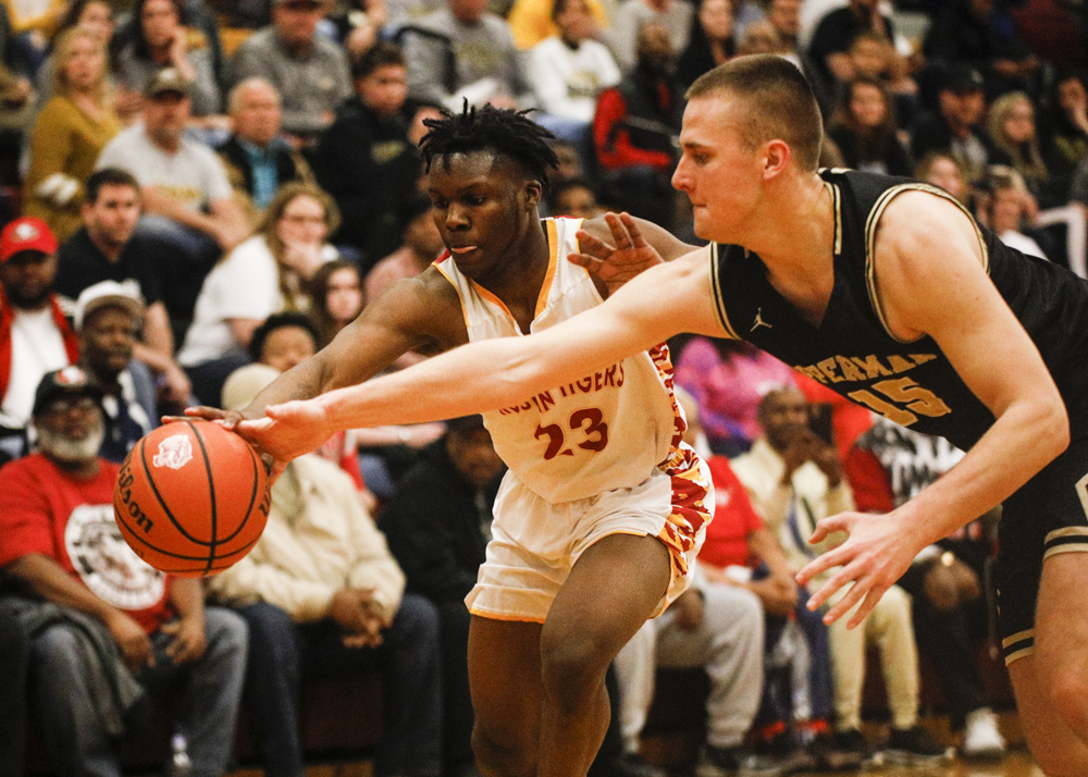 Staff photo by Troy Stolt / Howard's Calvin James (23) and Upperman's Filip Balic (15) compete for a loose ball during the boys' Class AA basketball sectional championship game between Upperman and Howard on Monday, March 9, 2020 in Chattanooga, Tenn. Upperman would win the game and advance to the state tournament.