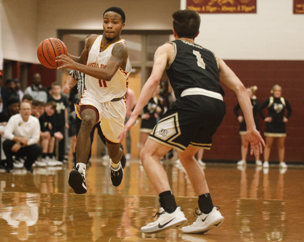 Staff photo by Troy Stolt / Howard's Xavier Fisher (11) brings the ball down court during the boys' Class AA basketball sectional championship game between Upperman and Howard on Monday, March 9, 2020 in Chattanooga, Tenn. Upperman would win the game and advance to the state tournament.