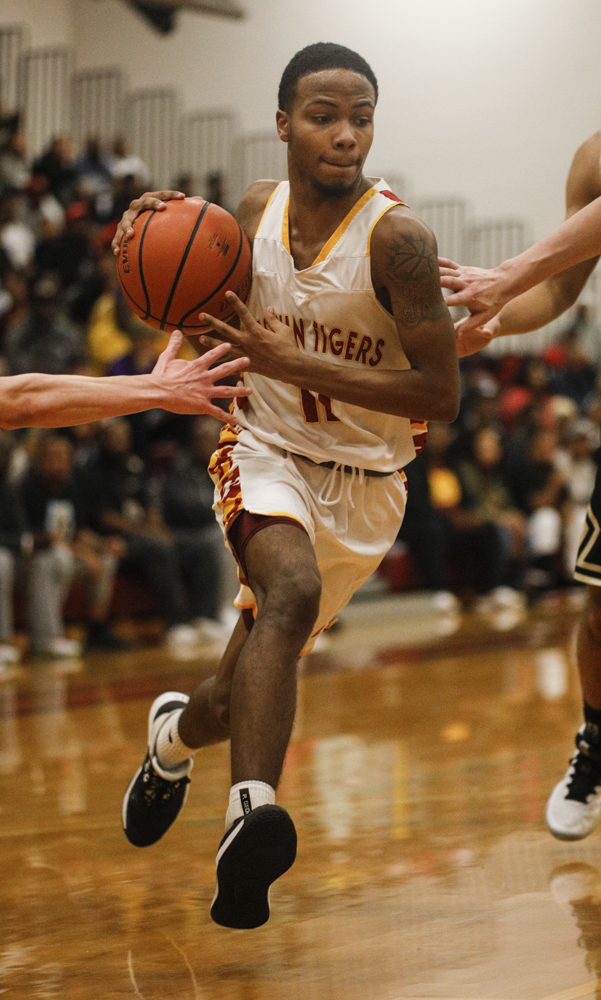 Staff photo by Troy Stolt / Howard's Xavier Fisher (11) drives the ball to the basket during the boys' Class AA basketball sectional championship game between Upperman and Howard on Monday, March 9, 2020 in Chattanooga, Tenn. Upperman would win the game and advance to the state tournament.