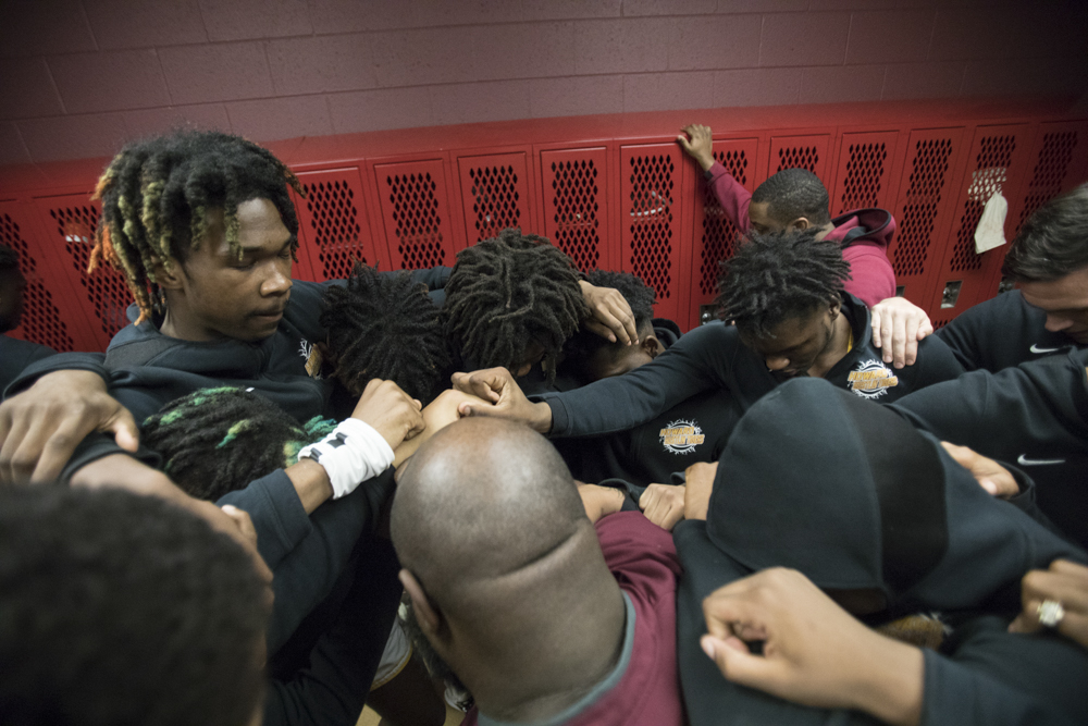 Staff photo by Troy Stolt / The Howard boys basketball team pray before the start of the boys' Class AA basketball sectional championship game between Upperman and Howard on Monday, March 9, 2020 in Chattanooga, Tenn. Upperman would win the game and advance to the state tournament.