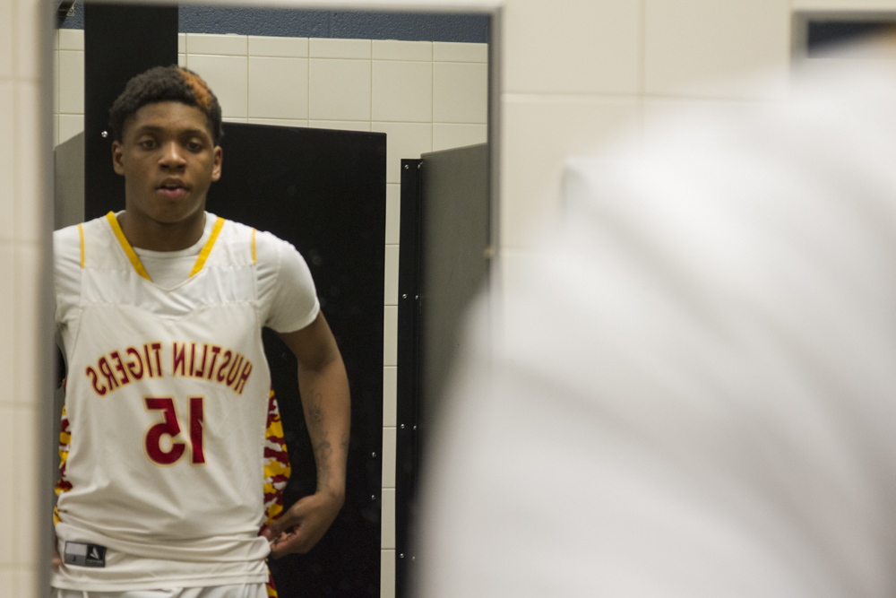 Staff photo by Troy Stolt / Howard's Micheal Wilson (15) inspects himself in the mirror before the start of the boys' Class AA basketball sectional championship game between Upperman and Howard on Monday, March 9, 2020 in Chattanooga, Tenn. Upperman would win the game and advance to the state tournament.