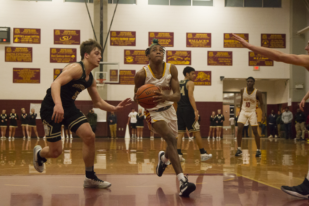 Staff photo by Troy Stolt / Howard's Dicourius Edward (3) drives to the basket during the boys' Class AA basketball sectional championship game between Upperman and Howard on Monday, March 9, 2020 in Chattanooga, Tenn. Upperman would win the game and advance to the state tournament.