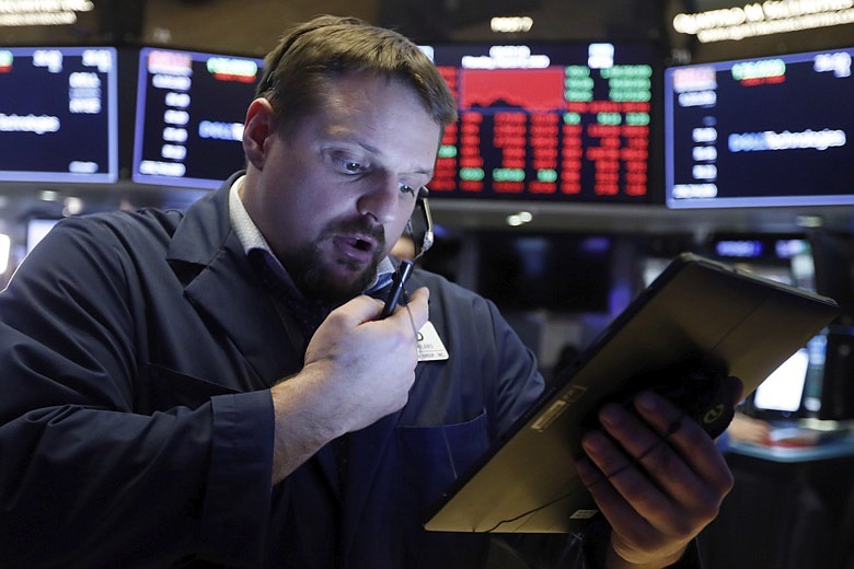 Trader Michael Milano works on the floor of the New York Stock Exchange, Monday, March 9, 2020. The Dow Jones Industrial Average sank 7.8%, its steepest drop since the financial crisis of 2008, as a free-fall in oil prices and worsening fears of fallout from the spreading coronavirus outbreak seize markets. (AP Photo/Richard Drew)