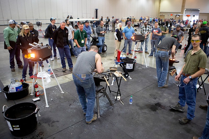Staff photo by C.B. Schmelter / People gather to watch as contestants participate in the Journeyman Class competition during the American Farriers' Association 2020 National Forging & Horseshoeing Competition and 49th Annual Convention at the Chattanooga Convention Center on Tuesday, March 10, 2020.