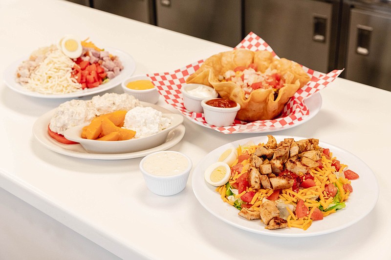 Salad choices at Track's End range from hearty to light lunches. Clockwise from top are a chef's salad, taco salad in fried tortilla shell, grilled chicken salad and homemade chicken salad plate. / Photo by Chloe Goodman