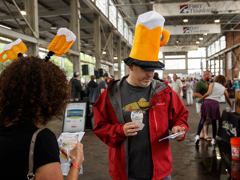 Staff File Photo/ James Barnes, right, and Erin Murphy wear beer-themed headgear at the 2019 Chattabrewga. This weekend's beer festival has a new location in The Signal.