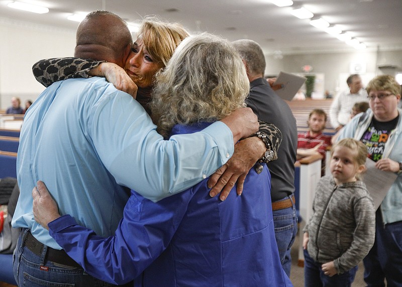 Staff photo by Troy Stolt / Wanda Harvey, center, Judy Hix, right, and Mike Phillips, left, embrace before a memorial service for 13-year-old Bridgett McCormick on Tuesday, March 10, 2020 at Sycamore Church of Christ in Cookeville, Tenn. McCormick was killed when an EF-4 tornado destroyed her home.