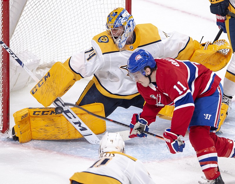 Nashville Predators goaltender Juuse Saros (74) makes a save on Montreal Canadiens right wing Brendan Gallagher (11) during the third period of an NHL hockey game Tuesday, March 10, 2020, in Montreal. (Ryan Remiorz/The Canadian Press via AP)