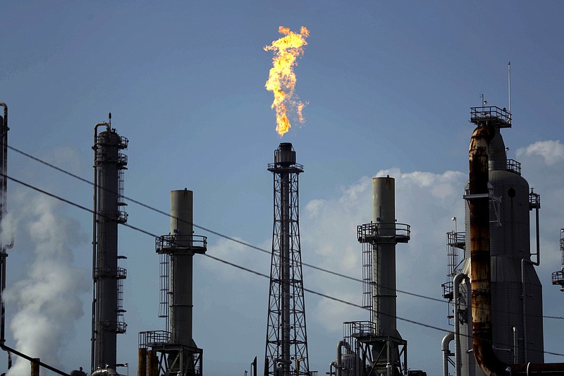 Photo by Gregory Bull of The Associated Press / In this Aug. 31, 2017, file photo, a flame burns at the Shell Deer Park oil refinery in Deer Park, Texas. Oil prices are plunging amid worries that an OPEC dispute will lead a coronavirus-weakened economy to be awash in an oversupply of crude.
