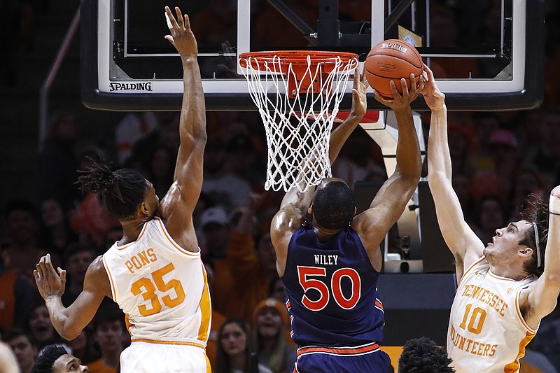 AP photo by Wade Payne / Tennessee forward John Fulkerson blocks Auburn center Austin Wiley's shot as Yves Pons helps on defense last Saturday in Knoxville.