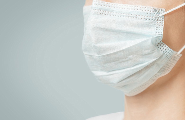 Woman in medical protective face mask against virus and infection diseases. / Getty Images/iStockphoto/Remains