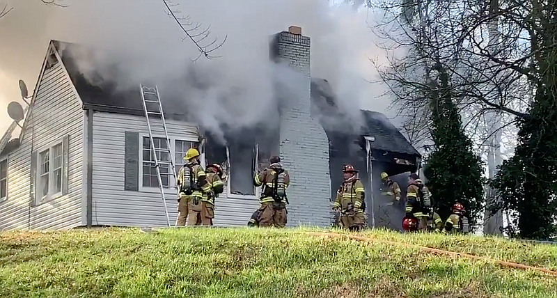 This screenshot from video shows Chattanooga firefighters responding to a house fire in East Brainerd on Wednesday, March 11, 2020. A firefighter rescued a child from the burning residence and three people were later hospitalized. / Screenshot from video posted by the Chattanooga Fire Department on Twitter