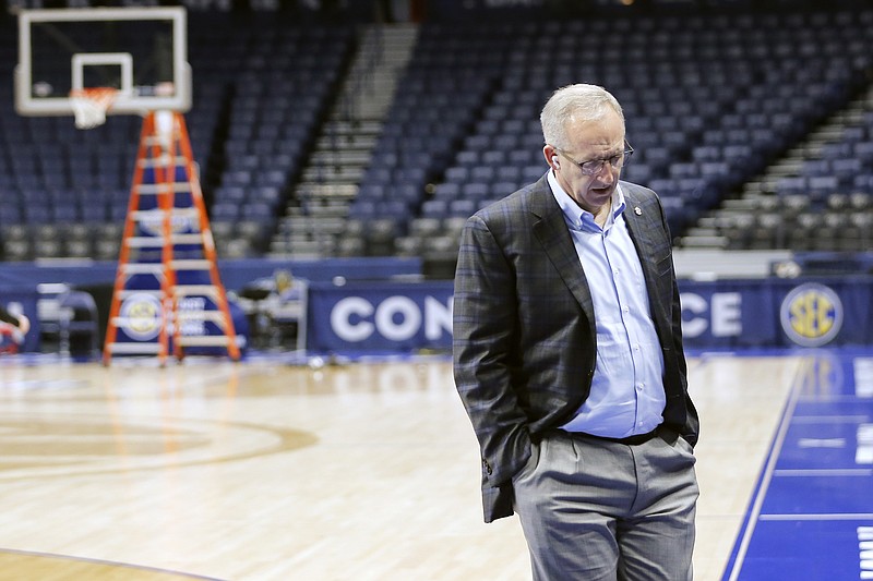 AP photo by Mark Humphrey / SEC commissioner Greg Sankey walks across the basketball court at Bridgestone Arena on Thursday after the league's men's tournament's remaining games in Nashville were canceled.