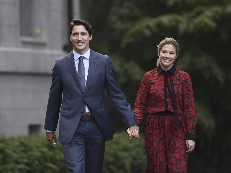 In this Wednesday, Sept. 11, 2019 photo, Canada's Prime Minister Justin Trudeau and his wife Sophie Gregoire Trudeau arrive at Rideau Hall in Ottawa, Ontario. Trudeau is quarantining himself at home after his wife exhibited flu-like symptoms. Trudeau's office said Thursday, March 12, 2020, that Sophie Grégoire Trudeau returned from a speaking engagement in Britain and had mild flu-like symptoms, including a low fever late, Wednesday night. (Justin Tang/The Canadian Press via AP