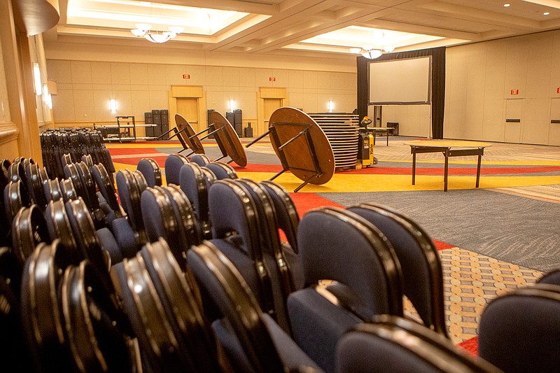 Staff photo by C.B. Schmelter / Chairs and tables are seen stacked up as a banquet hall in the Chattanooga Convention Center is being flipped for another event after the annual Catholic Charities Dinner was cancelled on Thursday, March 12, 2020 in Chattanooga, Tenn.
