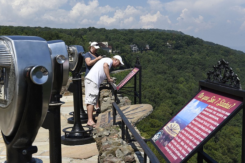 Staff File Photo / Mike and Gale Nickels, from Southgate, Mich., look off the bluff at Lover's Leap at Rock City. The attraction has closed due to the coronavirus threat, with an anticipated open date of March 28.