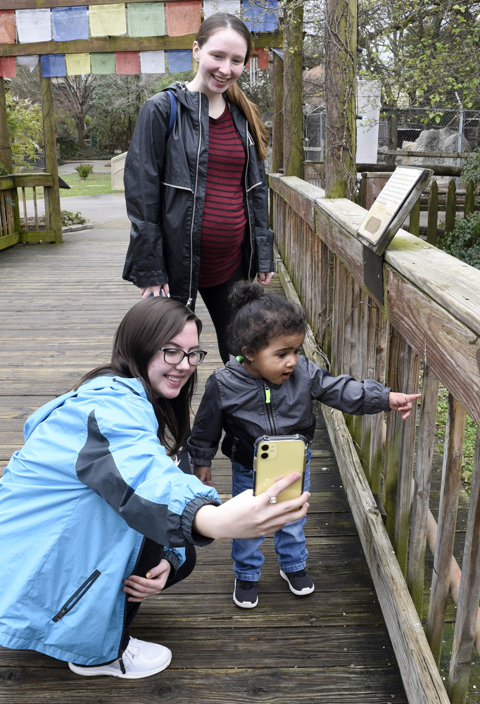 Staff Photo by Robin Rudd / Kayley Martin takes s photo of nephew Kaiden Davis and Kaiden's mom, Kaleena Martin.  Kaiden is much more impressed by the peacock at zoo than having his photo made.  The Chattanooga Zoo was one of the few attractions open, following the coronavirus warnings, on March 14, 2020.