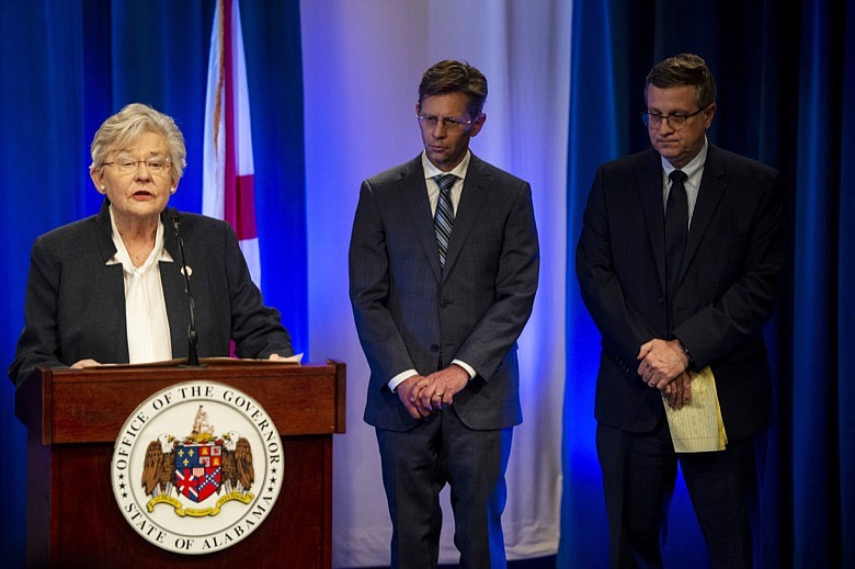 Alabama Gov. Kay Ivey speaks as State Superintendent of Education Eric Mackey and State Health Officer Scott Harris, right, wait to speak during a coronavirus news conference in Montgomery, Ala., Friday, March 13, 2020. (Jake Crandall/The Montgomery Advertiser via AP)