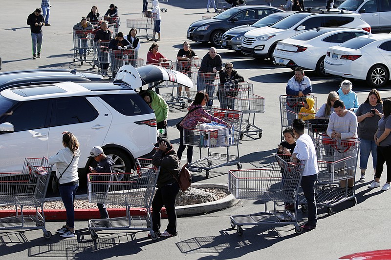 A line of people waiting to buy supplies amid coronavirus fears snakes through a parking lot at a Costco, Saturday, March 14, 2020, in Las Vegas. For most people, the new coronavirus causes only mild or moderate symptoms. For some it can cause more severe illness, especially in older adults and people with existing health problems. (AP Photo/John Locher)


