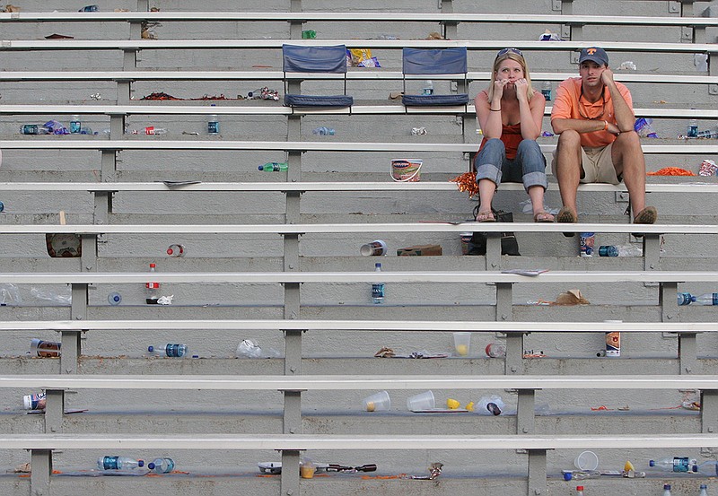 Staff photo / Atlanta residents Crystal Yates, a 2005 graduate of the University of Tennessee, and Chris Schmaker hold back tears while staring at an empty field after their Vols lost 14-12 at Auburn on Sept. 27, 2008.