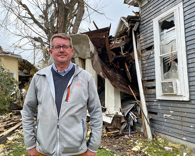 In this on March 10, 2020 photo, historian Robbie Jones stands in front of his damaged office building in East Nashville, Tenn., a week after a tornado pummeled the neighborhood.(Samantha Max/WPLN News via AP)