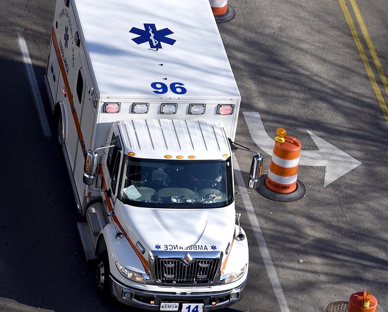 A Hamilton County EMS ambulance races south on Market Street / Staff Photo by Robin Rudd