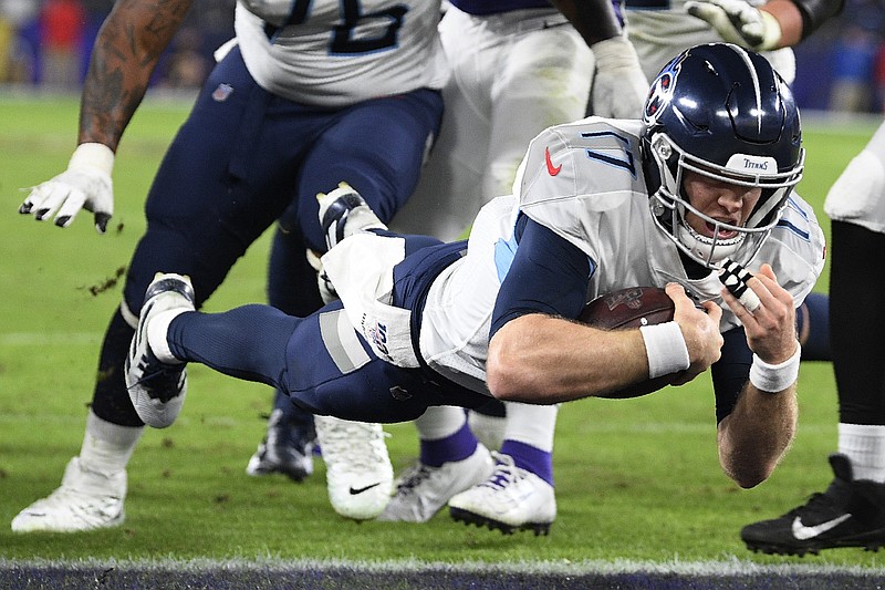 AP photo by Nick Wass / Tennessee Titans quarterback Ryan Tannehill leaps into the end zone for a touchdown against the host Baltimore Ravens during the second half of a divisional round playoff game on Jan. 11.