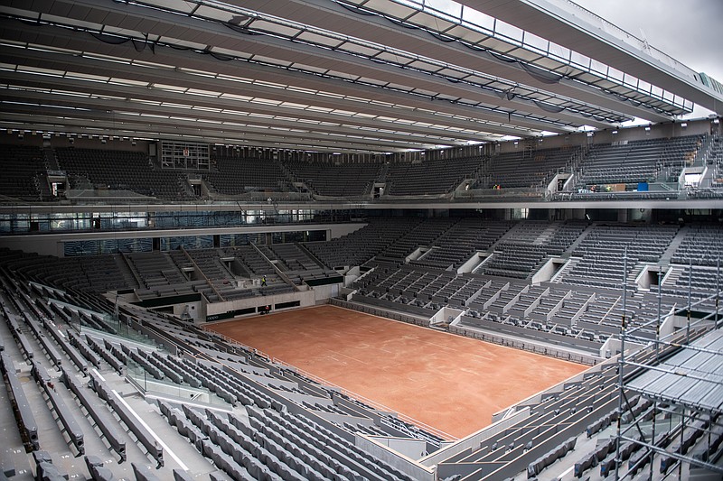 FILE - In this Feb. 5, 2020, file photo, construction work of the newly built roof of the Philippe Chatrier center court is pictured at Roland Garros stadium in Paris. The French Open has been postponed because of the coronavirus. The French Tennis Federation announced Tuesday, March 17, 2020, that the clay-court event will run from Sept. 20 to Oct. 4. Main draw competition was supposed to start on May 24. (Martin Bureau/Pool via AP, File)


