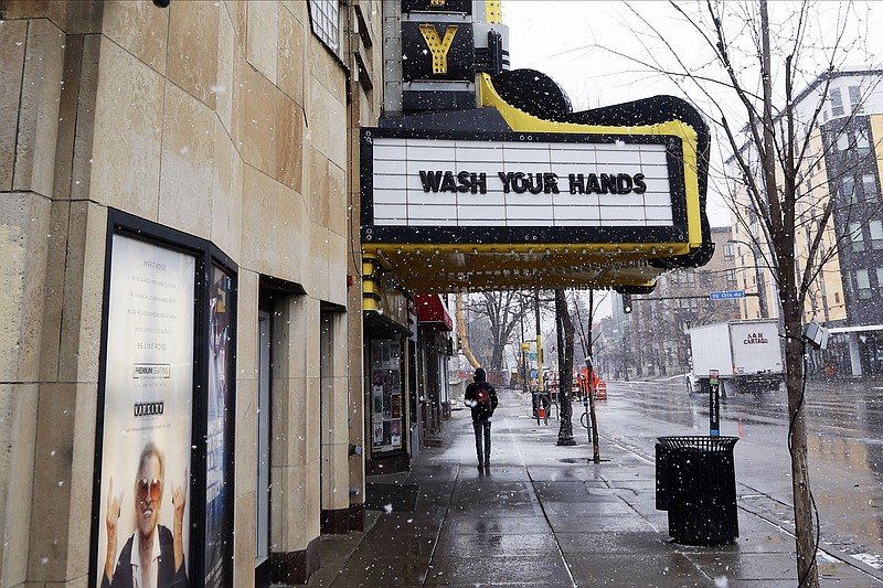 The Varsity Theater, home to concerts, used the marquee to address the need for washing hands due to the coronavirus, the disease that is caused by the new coronavirus, Monday, March 16, 2020 near the University of Minnesota in Minneapolis. (AP Photo/Jim Mone)