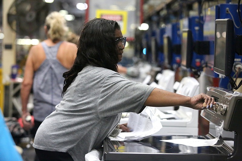 Staff file photo / Roxanne Adams performs tests on stoves as they move down the assembly line Friday, Sept. 20, 2019 at the GE Appliances' Roper Plant in LaFayette, Georgia.