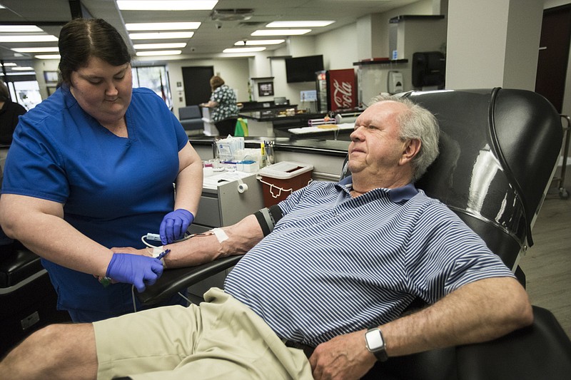 Staff photo by Troy Stolt / Kayla Derryberry helps Butch Lundsford start his blood donation at Blood Assurance on Wednesday, March 18, 2020 in Chattanooga, Tenn. Blood Assurance has reported a loss of 1,000 units of blood in the recent weeks due to blood drives being cancelled in the five states it operates in, which has created a need for donors to come forward in Hamilton County.