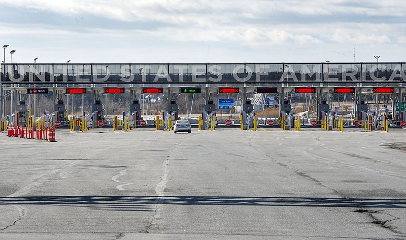 A vehicle approaches the only open lane at the United States border crossing in Lacolle, Quebec, Wednesday, March 18, 2020. The Canada-U.S. border will be closed to non-essential traffic in both directions "by mutual consent," President Donald Trump confirmed Wednesday, as efforts across the continent to contain the widening COVID-19 pandemic continued to upend daily life in North America. (Ryan Remiorz/The Canadian Press via AP)


