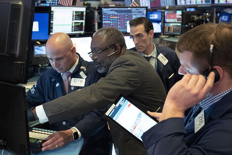 Traders at the New York Stock Exchange work as the market closes, Wednesday, March 18, 2020 in New York. (AP Photo/Mark Lennihan)