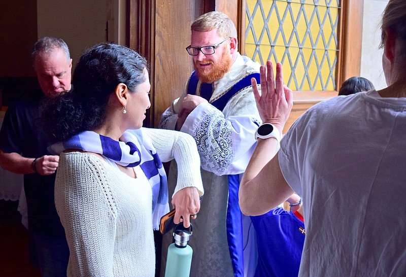 Staff Photo by Robin Rudd / Rev. David Carter gives a elbow bump with a parishioner after Mass.  Because of the Coronavirus Pandemic the last public Mass was offered at the Minor Basilica of Saints Peter and Paul, on the Feast of St. Joseph, on March 19, 2020.  