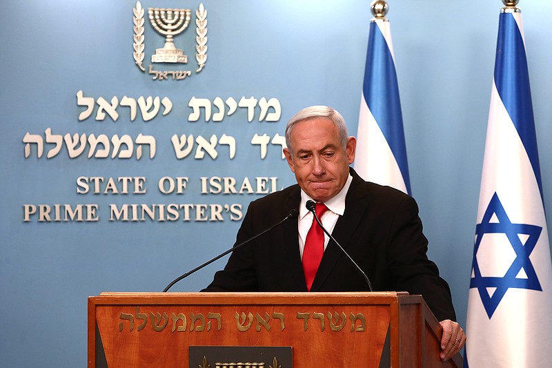 Prime Minister Benjamin Netanyahu delivers a speech from his Jerusalem office on Saturday, March 14, 2020, saying Israel's restaurants and places of entertainment will be closed to stop the spread of the coronavirus. He also encouraged people not to go to their workplaces unless absolutely necessary. (Gali Tibbon/Pool via AP)
