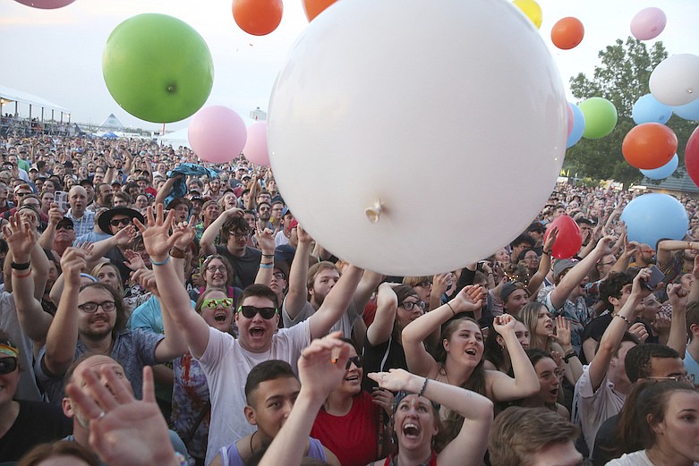 In this May 6, 2018, file photo fans take in The Flaming Lips performance at Beale Street Music Festival in Memphis, Tenn. The Beale Street Music Festival and the World Championship Barbecue Cooking Contest in Memphis have been postponed because of the new coronavirus outbreak. Memphis in May officials said in a statement Thursday, March 19, 2020, that the two cornerstones of the city's month-long tourist event have been called off but will be rescheduled for later dates. (Photo by Laura Roberts/Invision/AP, file)
