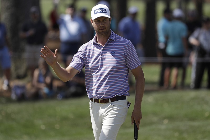 AP photo by Chris O'Meara / Harris English acknowledges the crowd after sinking a 35-foot birdie putt during the opening round of The Players Championship golf tournament on March 12 in Ponte Vedra Beach, Florida. English shot a 7-under-par 65, but the tournament was canceled that night.