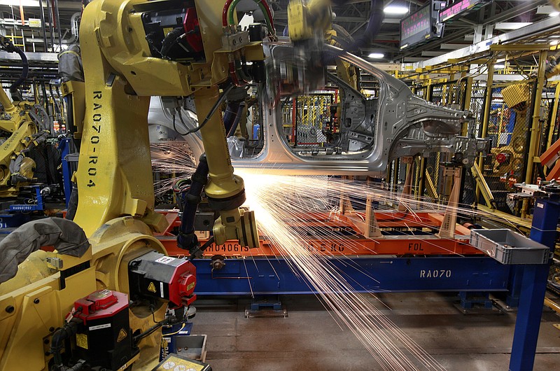 In this May 19, 2011 photo, robots weld a Chevrolet Sonic at the General Motors Orion Assembly plant in Orion Township, Mich. General Motors, Ford, jet engine maker Rolls-Royce and other companies are talking to their governments about repurposing idled factories to produce vital goods to fight the coronavirus such as ventilators and surgical masks. On Friday, March 20, 2020 President Donald Trump invoked the Korean War-era Defense Production Act, allowing the government to marshal the private sector to fight the COVID-19 pandemic. Although it allows the government to steer factories to overcome shortages, makers of heavy goods such as cars and trucks can't just flip a switch and produce something else. (AP Photo/Paul Sancya)


