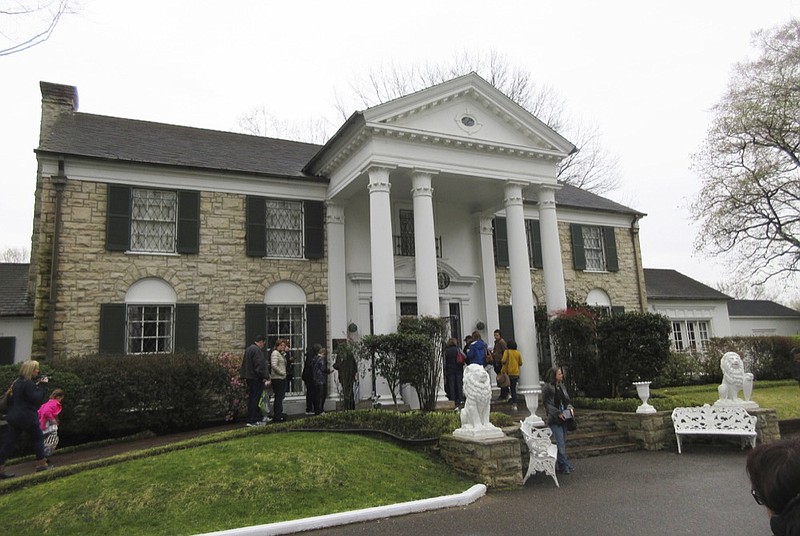 FILE - In this March 13, 2017, file photo, visitors get ready to tour Graceland in Memphis, Tenn. Elvis Presley's Graceland is closing in response to the coronavirus outbreak, Friday, March 20, 2020.(AP Photo/Beth J. Harpaz)


