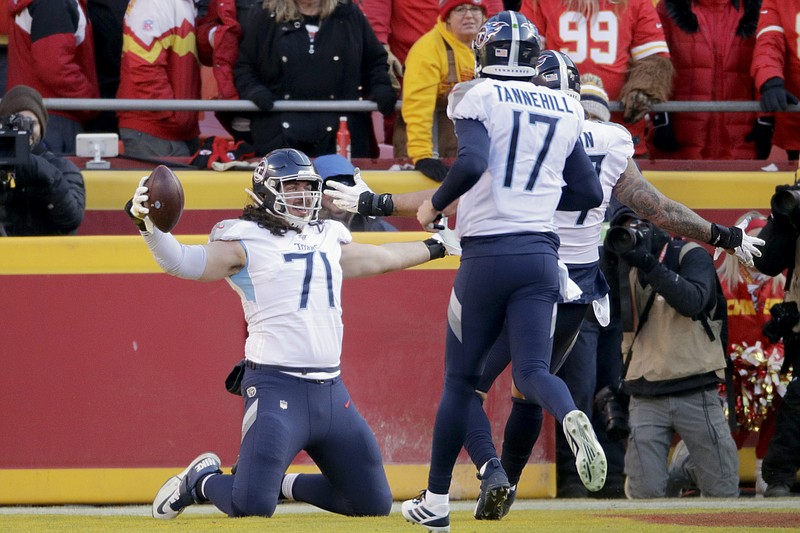 AP photo by Charlie Riedel / Tennessee Titans offensive linemann Dennis Kelly (71) celebrates his touchdown catch with quarterback Ryan Tannehill during the first half of the AFC championship game against the host Kansas City Chiefs on Jan. 19.