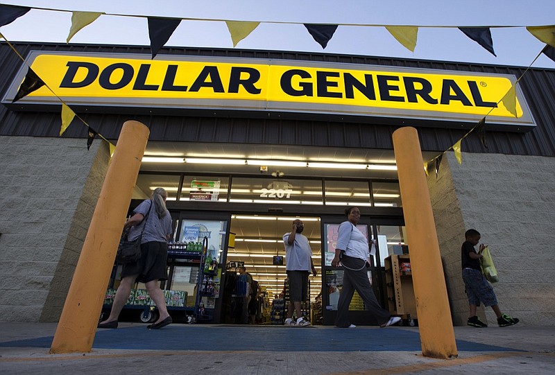 In this Wednesday, Sept. 25, 2013, photo, customers exit a Dollar General store, in San Antonio. Dollar General, a U.S. discount chain, has tripled its profits in three years due in part to the increased interest in discount shopping. (AP Photo/Eric Gay)